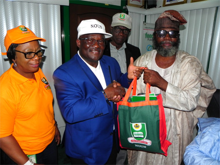 NOUN Vice Chancellor Professor Vicent A. Tenebe Presenting NOUN Souvenair To Professor Olufeysan Taiwo Feyi-Sobanjo During The signing ceremony
