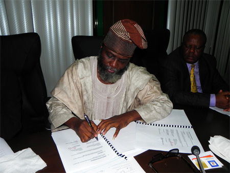 The Head, IPMA Africa Regional Office, Professor Olufeysan Taiwo Feyi-Sobanjo signing The IPMA-NOUN MOU